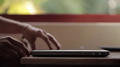 Close-up of female hands opens and switch on the laptop Stock Footage