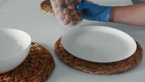 Close-up female hands opens a jar of whole walnuts on the white table. Stock-Footage 151994492