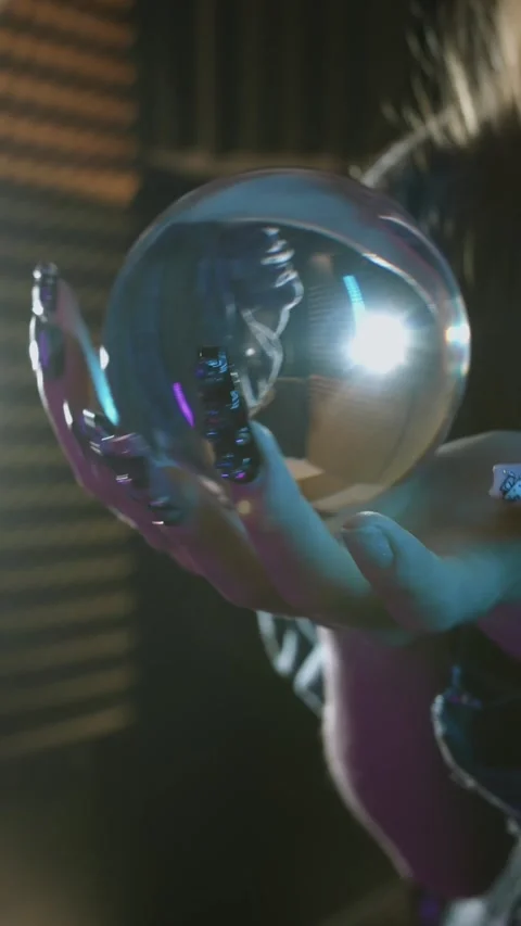 Close-up of female hands performing a trick with a glass ball - contact juggling Stock Footage 328144693