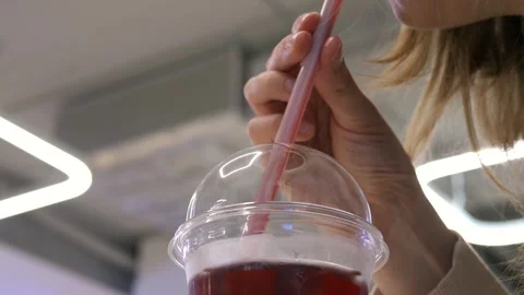 Close-up of female hands placing a cold drink with ice Video stock 311770328