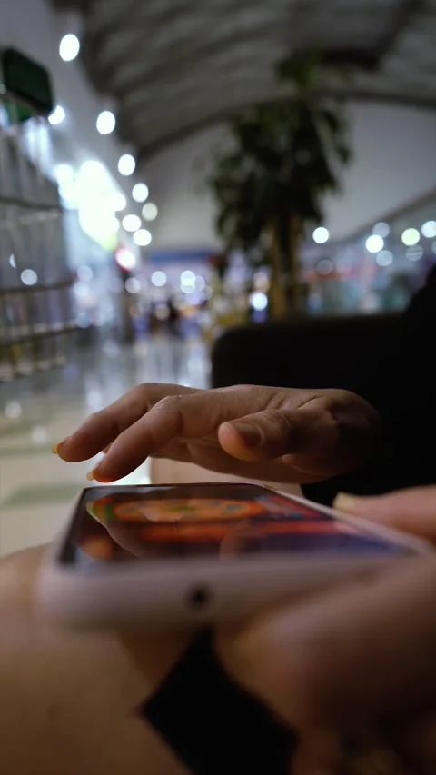 Close up of female hands playing video game on smartphone in the mall Stock Footage 193277245