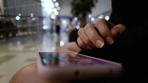 Close up of female hands playing video game on smartphone in the mall Stock Footage 193277367