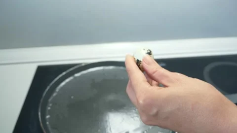 Close up female hands prepare fried eggs from quail eggs Stock Footage 134471433
