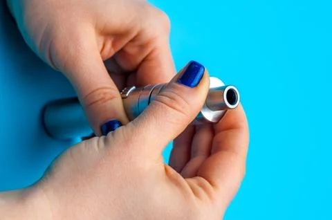 Close-up - female hands preparing device to vaping e-cigarette. Stock Photos