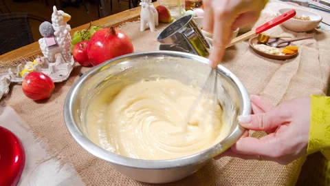 Close-up of female hands preparing dough for delicious muffins using a whisk Stock Footage 153479984