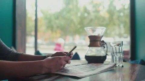 Close-up of female hands print sms on your mobile phone in a cafe Stock Footage 69744015