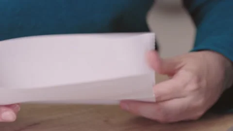 Close-up female hands pull out paper envelope utility bill paper letter bank 動画素材 223411696