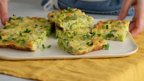 Close-up. Female hands put broccoli frittata on a plate. Italian breakfast Video stock 146924187