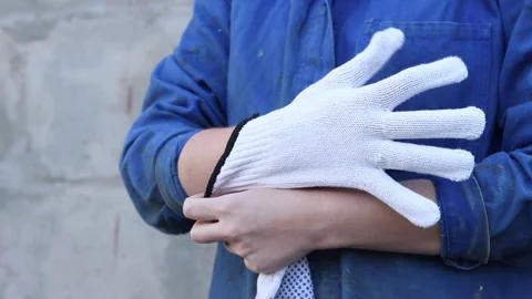 Close-up of female hands putting on construction gloves Stock Footage 317077986