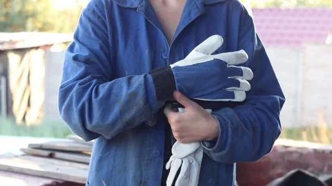 Close-up of female hands putting on construction gloves Stock Footage 317714138