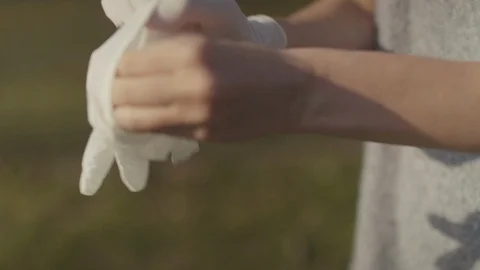 Close up of female hands putting white antbacterial gloves. Видео 129255751