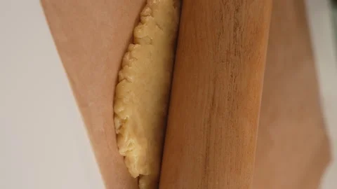 Close up of female hands rolling dough on kitchen table for cookies by rolling p Stock Footage 263241139