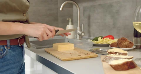 Close up of female hands slicing cheese for sandwiches in the kitchen. Stock Footage 135043663