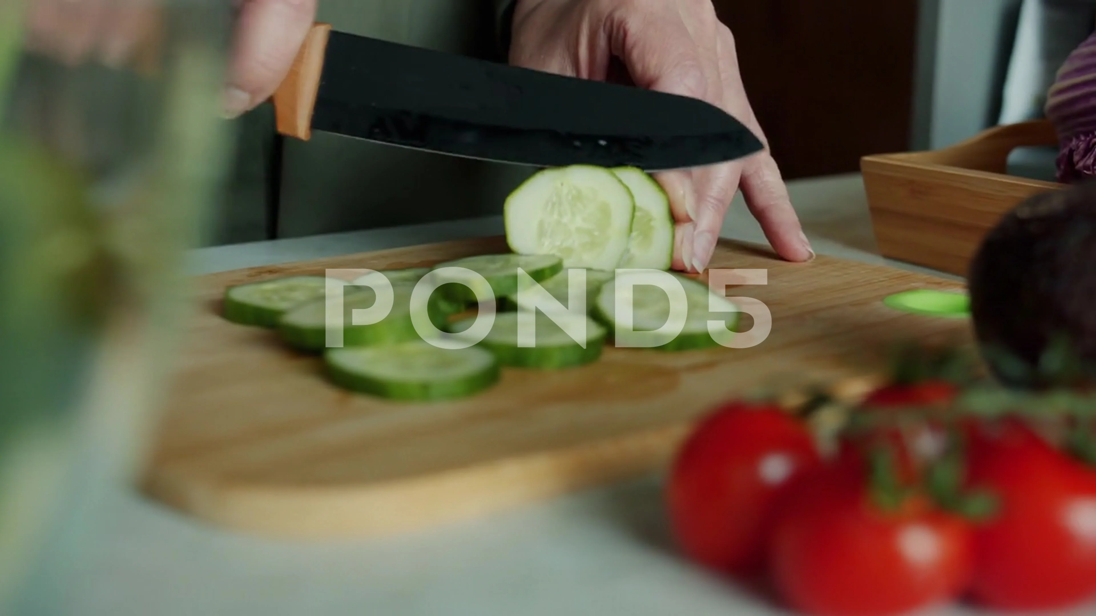 Female hand holding a cucumber with a spiral knife