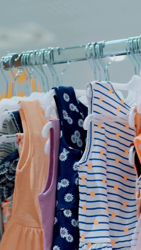 Close-up, female hands sorted out many hangers with outfits. selection and Stock Footage 321534753