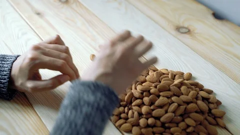 Close up of female hands sorting almonds Stock Footage 118690436