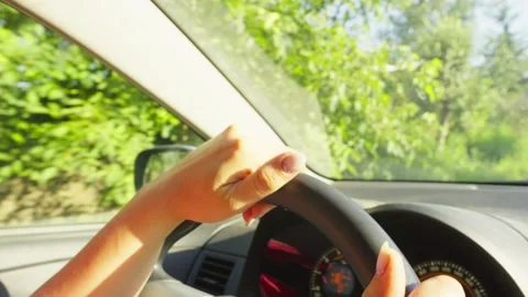 Close-up of female hands on the steering wheel of a car. Stock Footage 253802058