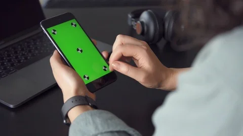 Close-up of female hands swipe down of smartphone. Green screen Stock Footage 105612662