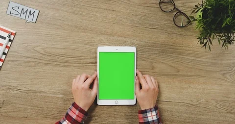 Close up on the female hands taping on the white vertical tablet device with a Stock Footage 89953728