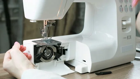 Close-up female hands test sewing machine after repair, pulling the thread Stock Footage 88520870