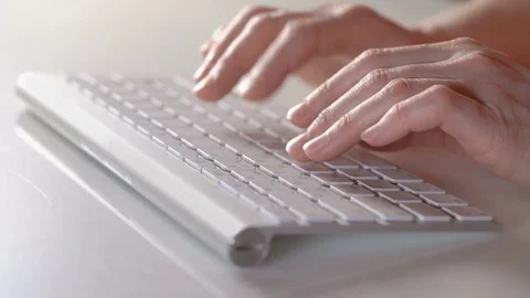 Close-up of female hands touching buttons of white keyboard Stock Footage 71710377