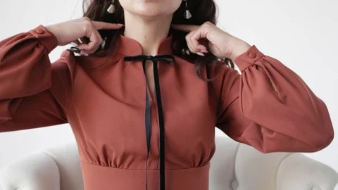 Close-up of female hands touching the collar of the dress. A delicate girl's Stock Footage 103731449