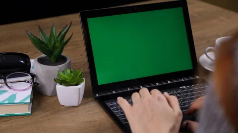 Close up of female hands typing and green laptop on the table. Stock Footage 107799763