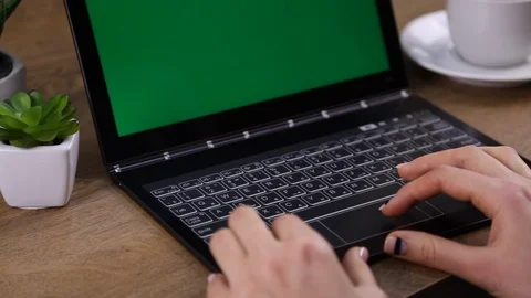 Close up of female hands typing and green laptop on the table. Stock Footage 107799798