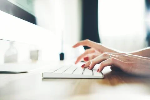 Close up of female hands typing on computer keyboard Stock Photos