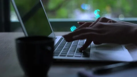 Close-up of female hands typing on a laptop keyboard in a modern office Stock Footage 345079570