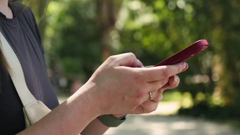 Close-up of female hands typing quickly on a smartphone screen. Online Stock Footage 336724272