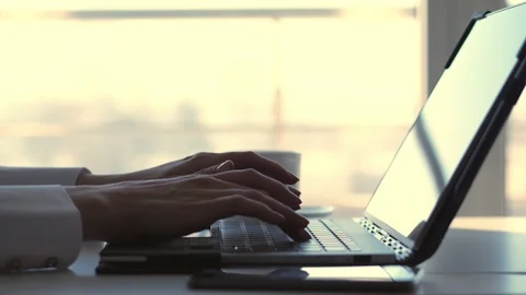 Close-up, female hands typing something on a laptop keyboard. At the same time Stock Footage 102376578