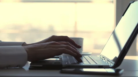 Close-up, female hands typing something on a laptop keyboard. at the same time Stock Footage 102376793