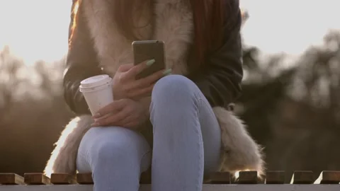 Close-up of female hands typing text message on her phone outdoors Stock Footage 166501658