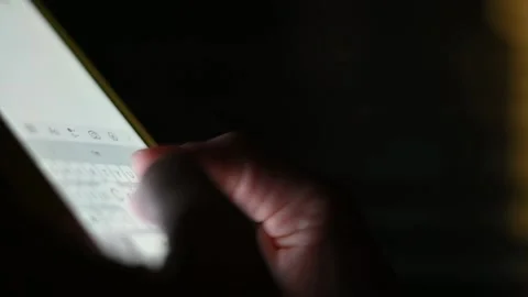Close-up of female hands typing text on the phone at night. Chatting, Internet Stockbeeldmateriaal 204984659