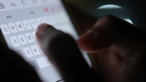 Close-up of female hands typing text on the phone at night. Chatting, Internet Stock Footage 204984711