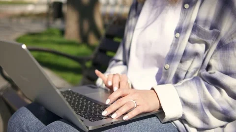 Close up female hands using keypad outdoors on a bench Stock Footage 272982006