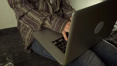 Close up of female hands using laptop sitting down on the floor at home, slow Stock Footage 72507032