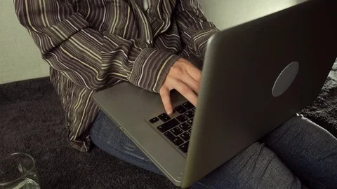 Close up of female hands using laptop sitting down on the floor at home Stock Footage 72526399