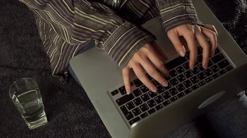 Close up of female hands using laptop sitting down on the floor at home, slow Stock Footage 72528111