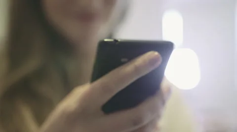 Close up of female hands using a mobile cell phone, indoors. Stock Footage