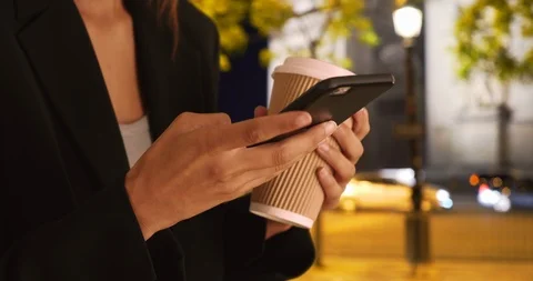 Close up of female hands using mobile phone to text message at night in Paris Stock Footage 88483363