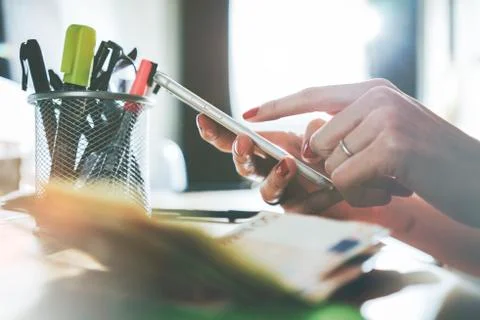 Close up of female hands using modern smart phone at office Stock Photos