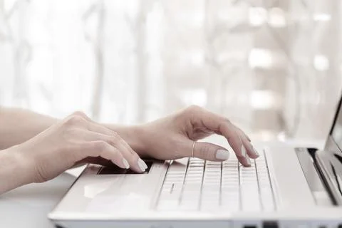 Close up of female hands using modern computer, high key. Blogger concept Stock Photos