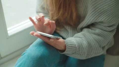 Close up of female hands using phone at home. 動画素材 88829692