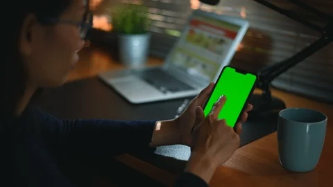 Close-up of female hands using a smart phone. chroma-key, green-screen Video stock 98434905