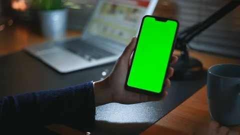 Close-up of female hands using a smart phone. chroma-key, green-screen Video stock 98434974