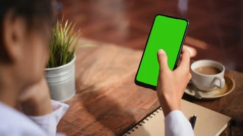 Close-up of female hands using a smart phone. chroma-key, green-screen Stock Footage 101944822