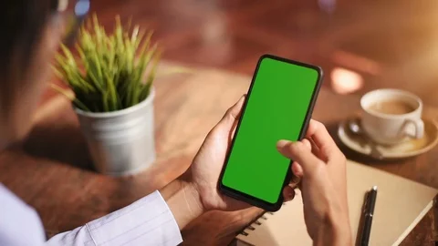 Close-up of female hands using a smart phone. chroma-key, green-screen Stock Footage 101946558
