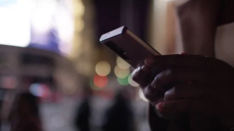 Close up of female hands using a smart phone in the city at night Stock Footage 252426182